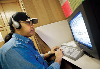 Security Officer Michael Rios makes good use of the computers at the Octavia Fellin Library in Gallup in this Feb. 24, 2010 file photo. 